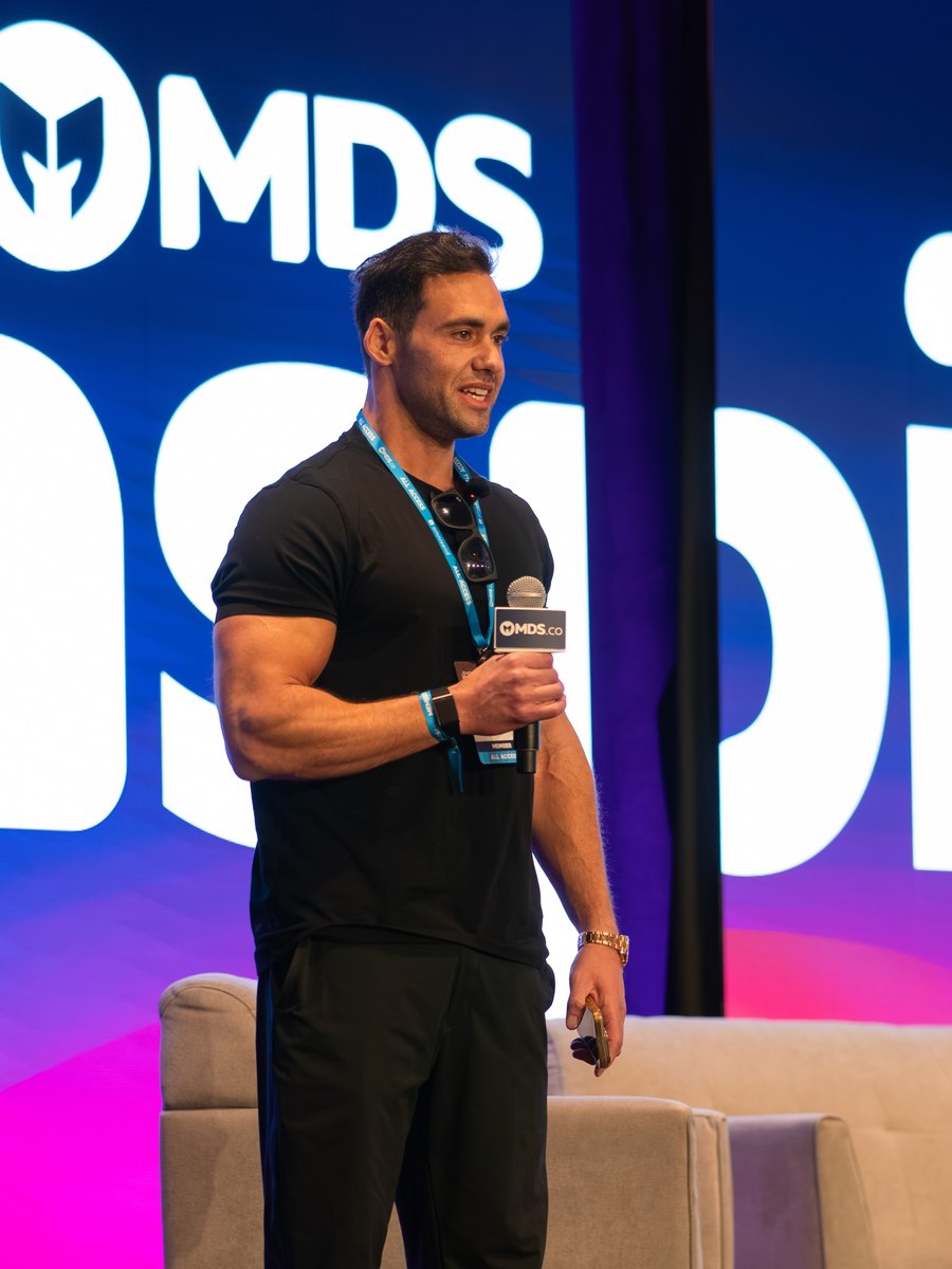 Hymie Zebede speaking on stage at MDS